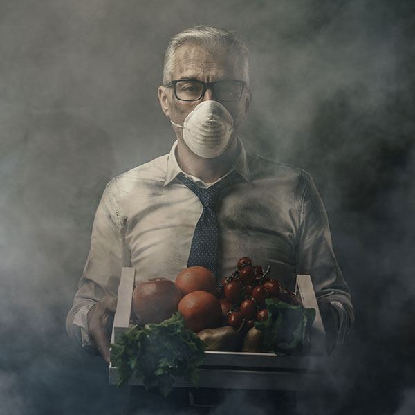 A man in a suit holds out a piece of glossy produce